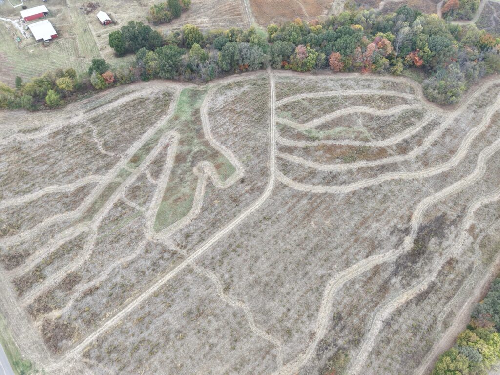 Aerial drone view of SeedTick Farm quail habitat with mowed paths and fall tree lines